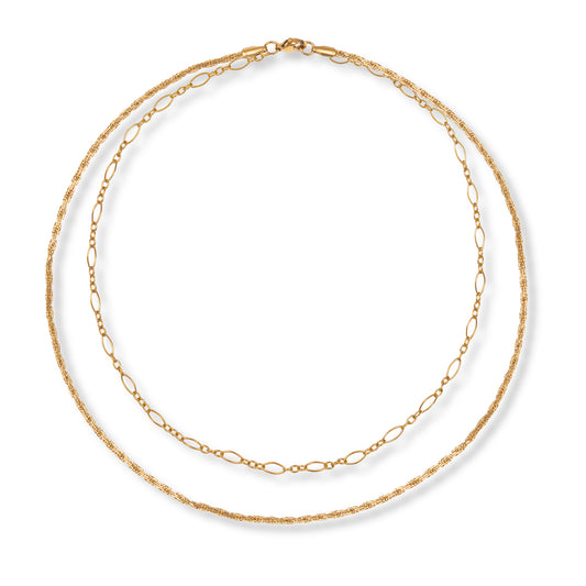 Two gold necklaces layered on top of each other, join at the top by a single clasp, on a white background.