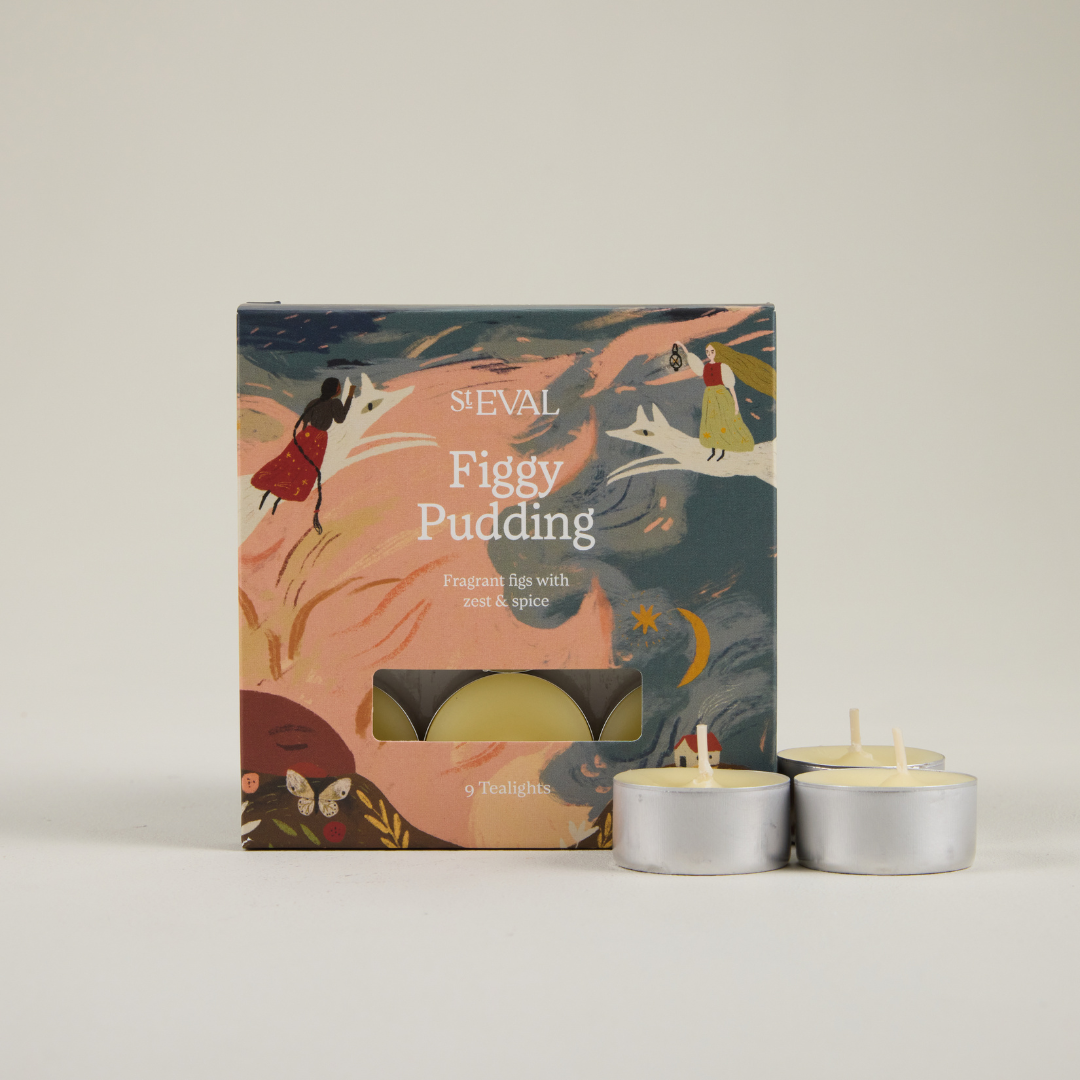 St Eval Figgy Pudding tealight candles with packaging on a neutral background.