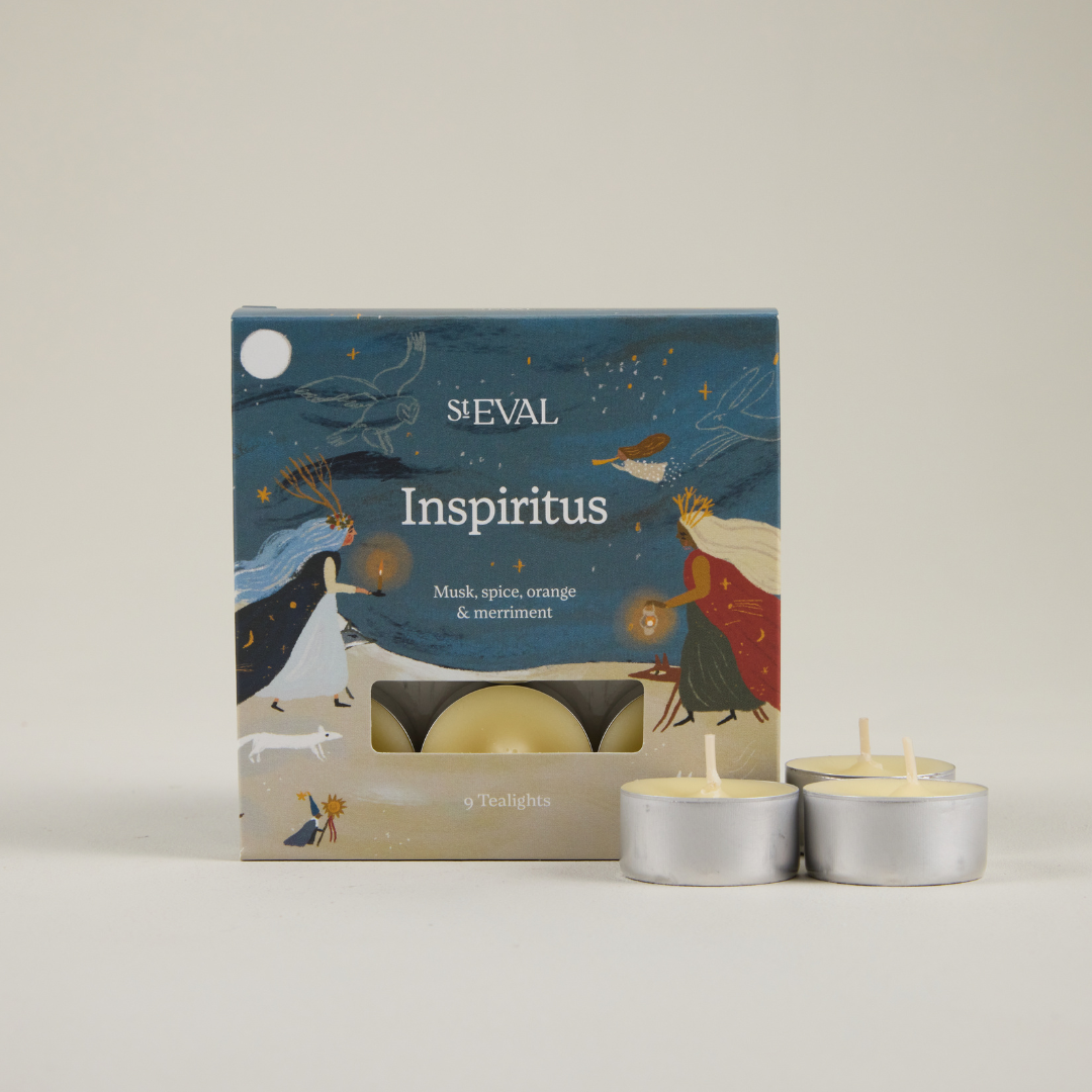 Packaging of St Eval Inspiritus tealights with two candles displayed in front on a light background.