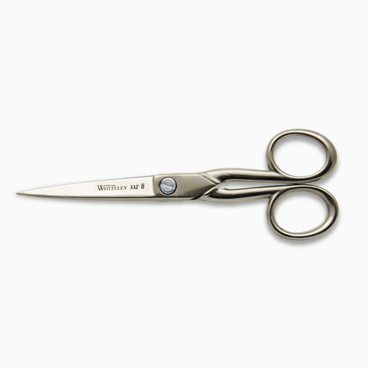 A pair of stainless steel scissors with a sleek design. The blades are sharp and pointed, and the handles are rounded for comfort. The brand name "Whiteley" is engraved on one side, indicating quality craftsmanship.