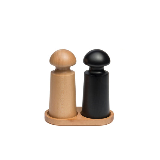 A wooden salt and pepper mill set featuring a light wood mill and a black mill, both with rounded tops. They are placed on a circular beech tray, creating a stylish and minimalist kitchen accessory.