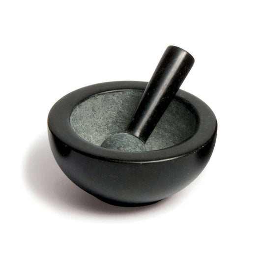 A black stone mortar and pestle set. The mortar has a smooth, rounded exterior and a contrasting textured interior. The pestle is cylindrical with a rounded end, resting inside the mortar, ready for grinding herbs or spices.