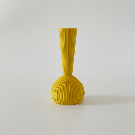 A yellow 3D printed vase with a long bottle neck top, set against a white background