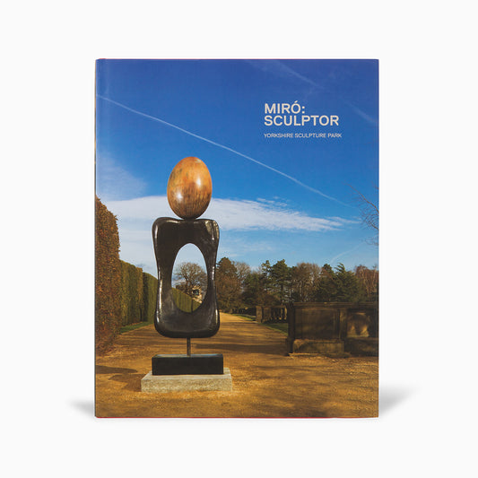A book cover featuring a sculpture by Joan Miró set in a park. The sculpture has a large oval top and an open centre, surrounded by neatly trimmed hedges and trees under a clear blue sky. The title reads "Miró: Sculptor" prominently at the top.