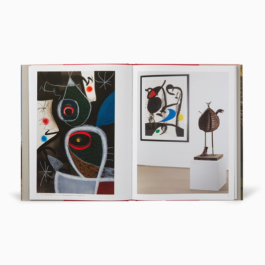 An open art book displays two pages. On the left, a vibrant abstract painting features bold colours and shapes. On the right, a framed artwork showcases a similar style, alongside a sculptural piece on a pedestal, set against a neutral background.
