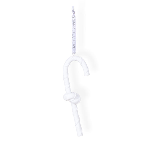 A white, twisted candy cane ornament hangs from a ribbon labelled "SNARKITECTURE." The design features a knot in the middle, giving it a unique and playful appearance, suitable for festive decorations.