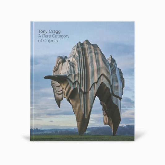 A book cover featuring a large, abstract sculpture resembling a natural formation, set against a cloudy sky. The title "Tony Cragg: A Rare Category of Objects" is displayed in the top left corner, with the author's name prominently featured.