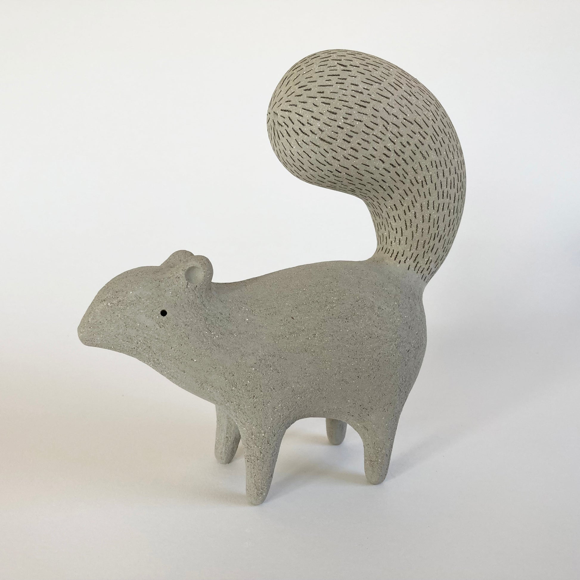 Gray ceramic squirrel figurine on a white background
