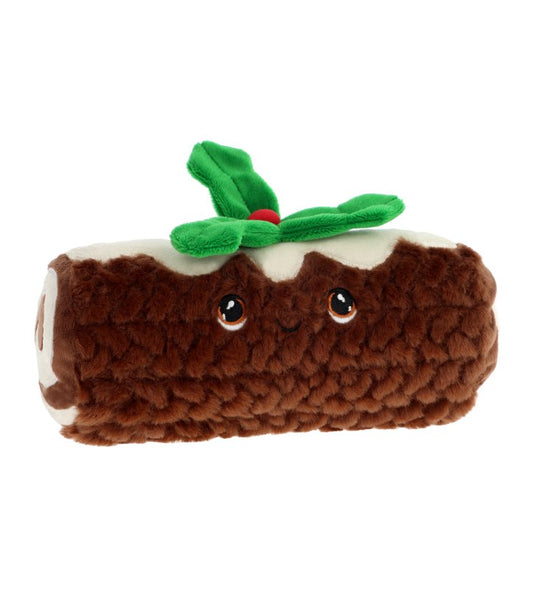 A plush toy shaped like a Christmas yule log, with brown textured sides, white top, and green leafy decoration on top, shown on a plain white background.