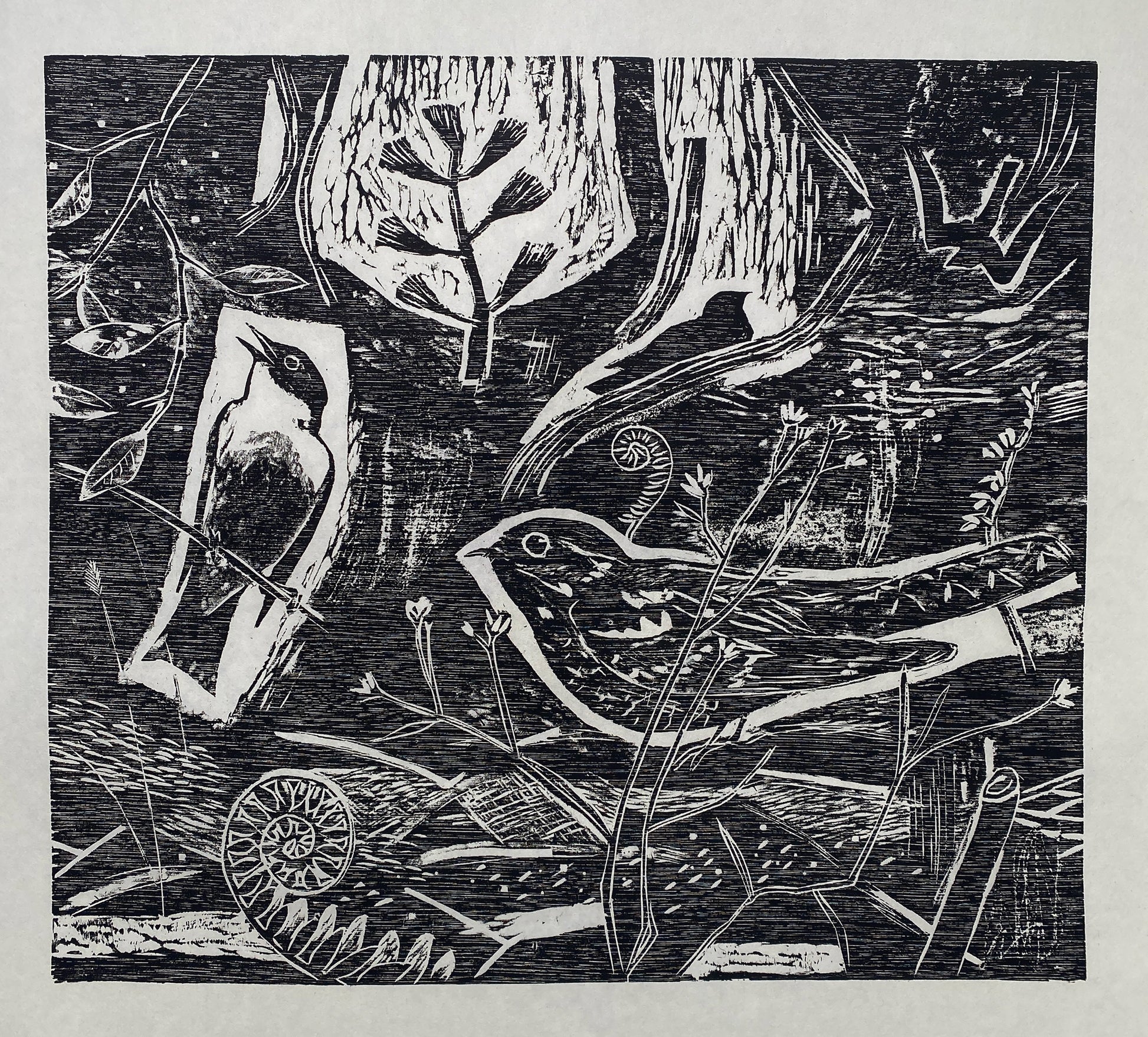 A black wood cut print showing two birds sitting on foliage and branches surrounded by more textured foliage.
