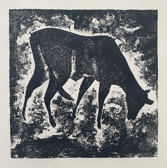 A black wood cut print with a single cow feeding with a textured background.