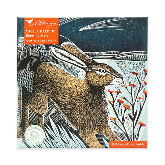 Jigsaw puzzle box featuring a hare linocut, there is orange foliage and a shooting star in the dark blue night sky within the background of the linocut. The box is square and is on a plain white background.