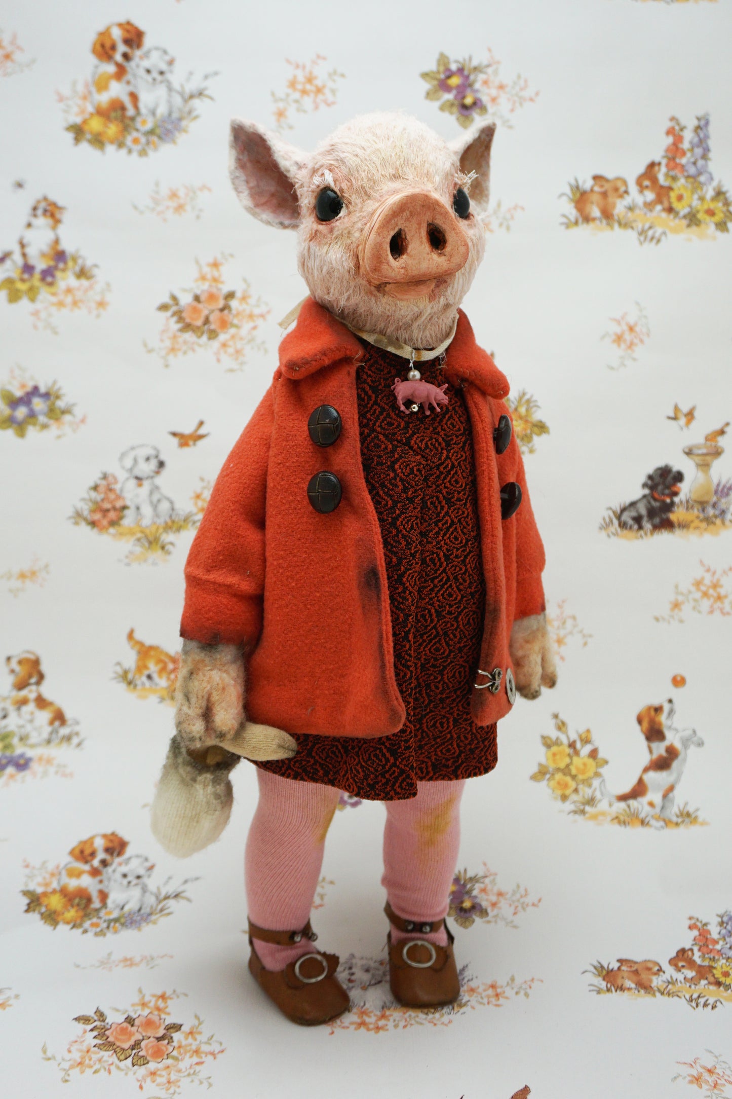 An anthropomorphic pig dressed in an orange coat, dark patterned dress, pink tights, and brown shoes, standing against a white background with a vintage-style animal print.