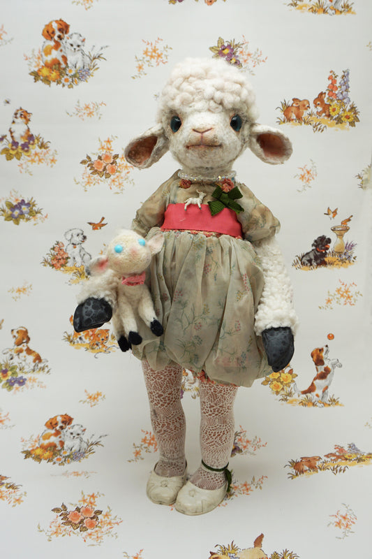A plush lamb toy dressed in a floral dress with a red sash, holding a smaller lamb toy. The background features a whimsical pattern of animals and flowers, including dogs and rabbits, in soft pastel colours.