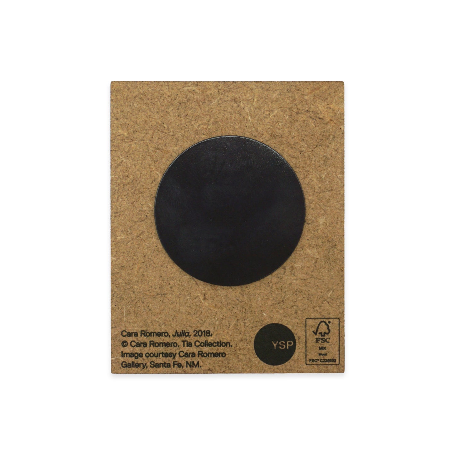 A MDF back with a black circular magnet in the centre. Text at the bottom includes the artist's name, Cara Romero, and details about the artwork's origin and copyright. The YSP logo and recycling symbols are also visible.