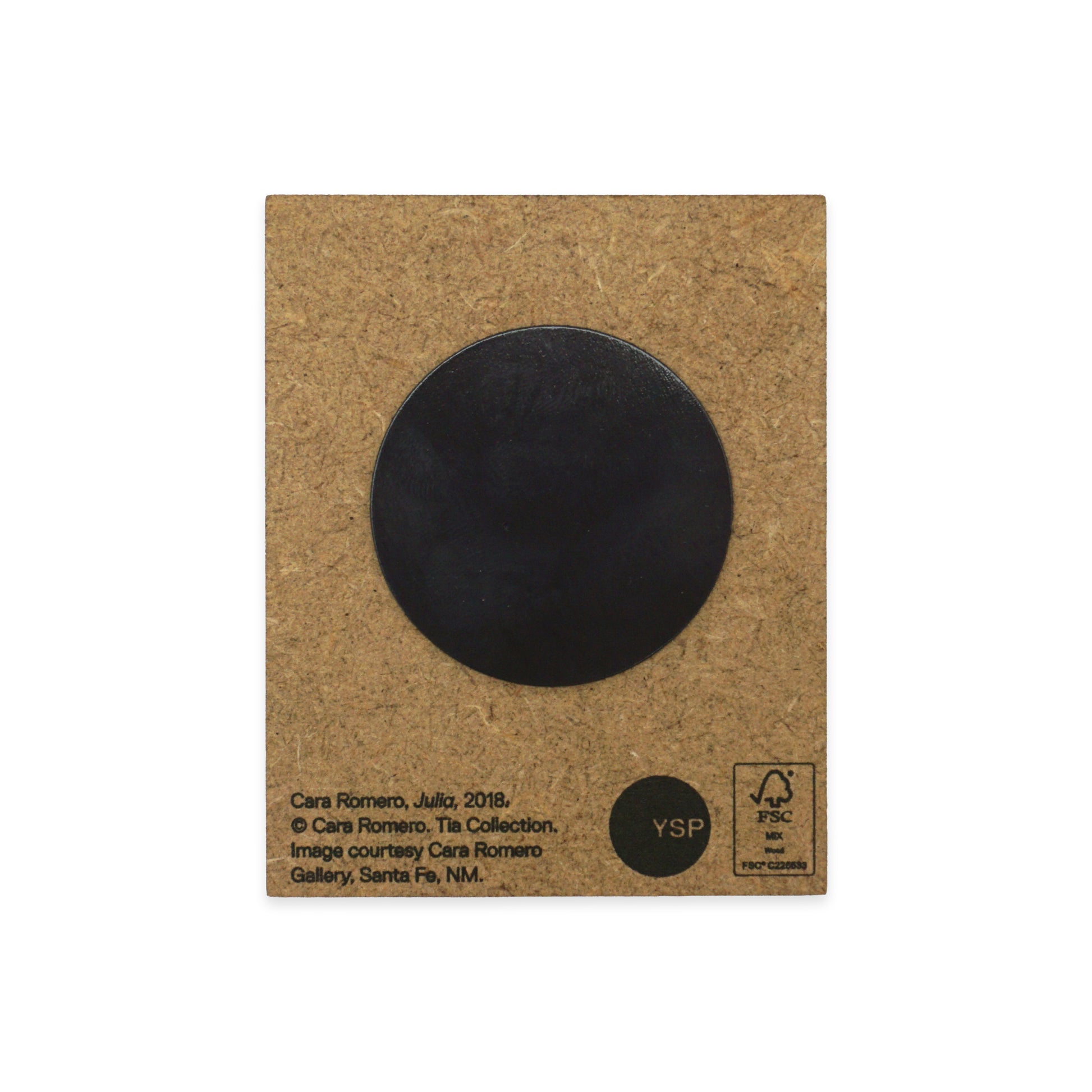 A MDF back with a black circular magnet in the centre. Text at the bottom includes the artist's name, Cara Romero, and details about the artwork's origin and copyright. The YSP logo and recycling symbols are also visible.