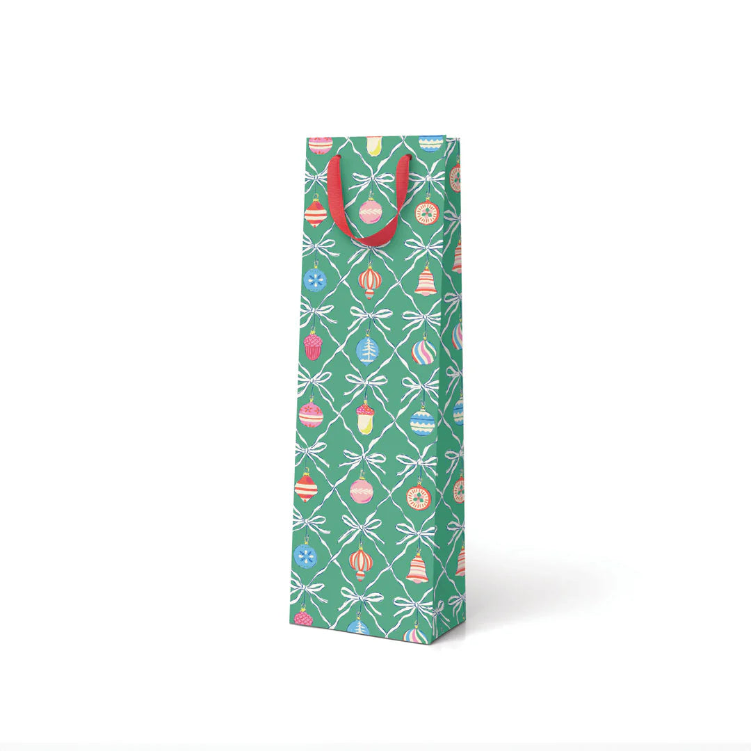 Gift bottle bag with festive design and red handles on a white background