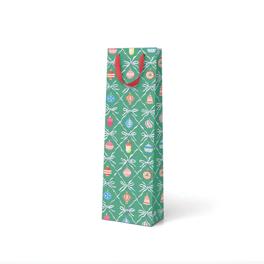Gift bottle bag with festive design and red handles on a white background