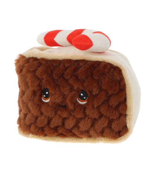 Plush toy resembling a slice of Christmas cake with a candy cane on top against a white background