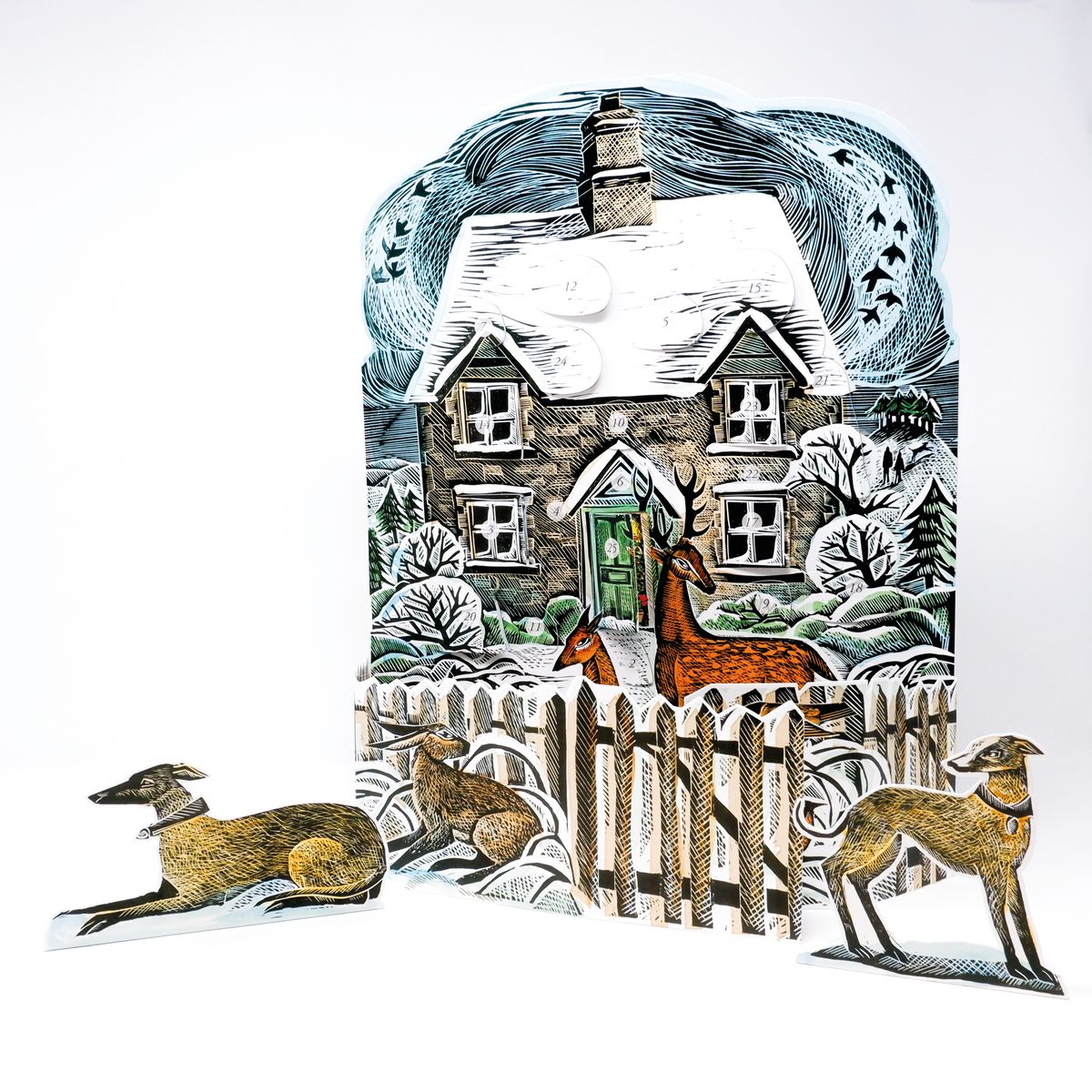 Advent calendar featuring a winter scene with a house, deer, and dogs in front of a fence on a white background