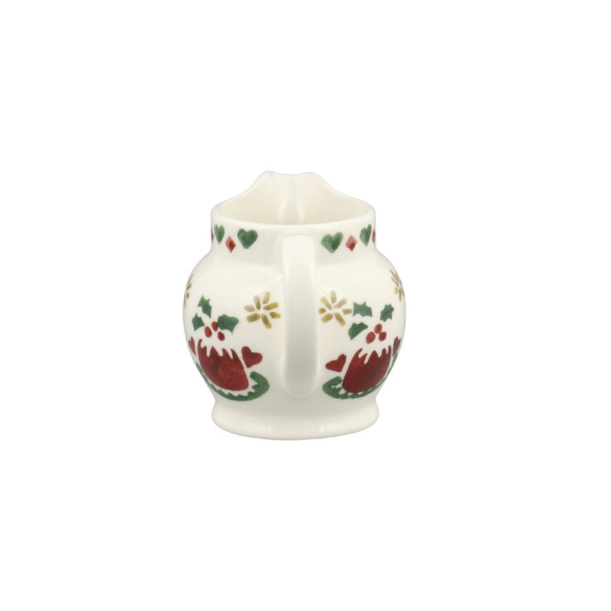 A small white ceramic pitcher decorated with a festive Christmas pattern featuring red Christmas puddings, green leaves, and gold stars, set against a plain white background.