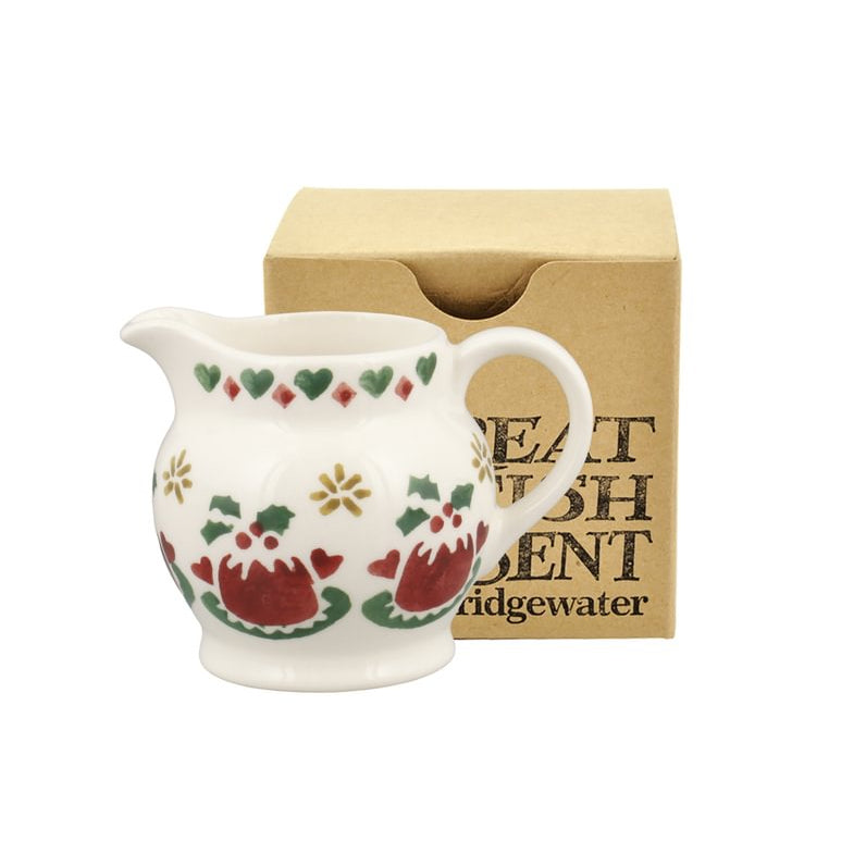 A small white ceramic pitcher with red and green Christmas pudding motifs, shown in front of a tan paper box printed with the brand name 'Emma Bridgewater'.