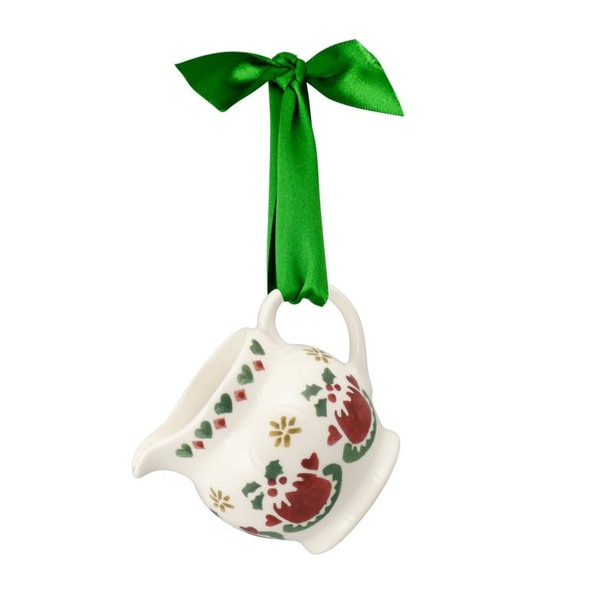 Decorative jug ornament with a green ribbon on a white background. The jug features whimsical illustrations of Christmas puddings, stars and hearts in shades of brown, green and gold.