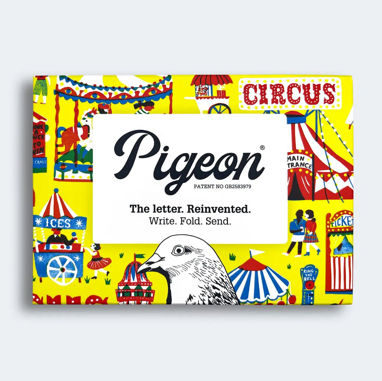 A vibrant, illustrated packaging featuring a whimsical circus theme with colourful tents, ice cream stalls, and playful characters. The centre displays the brand name "Pigeon" and the tagline "The letter. Reinvented. Write. Fold. Send.
