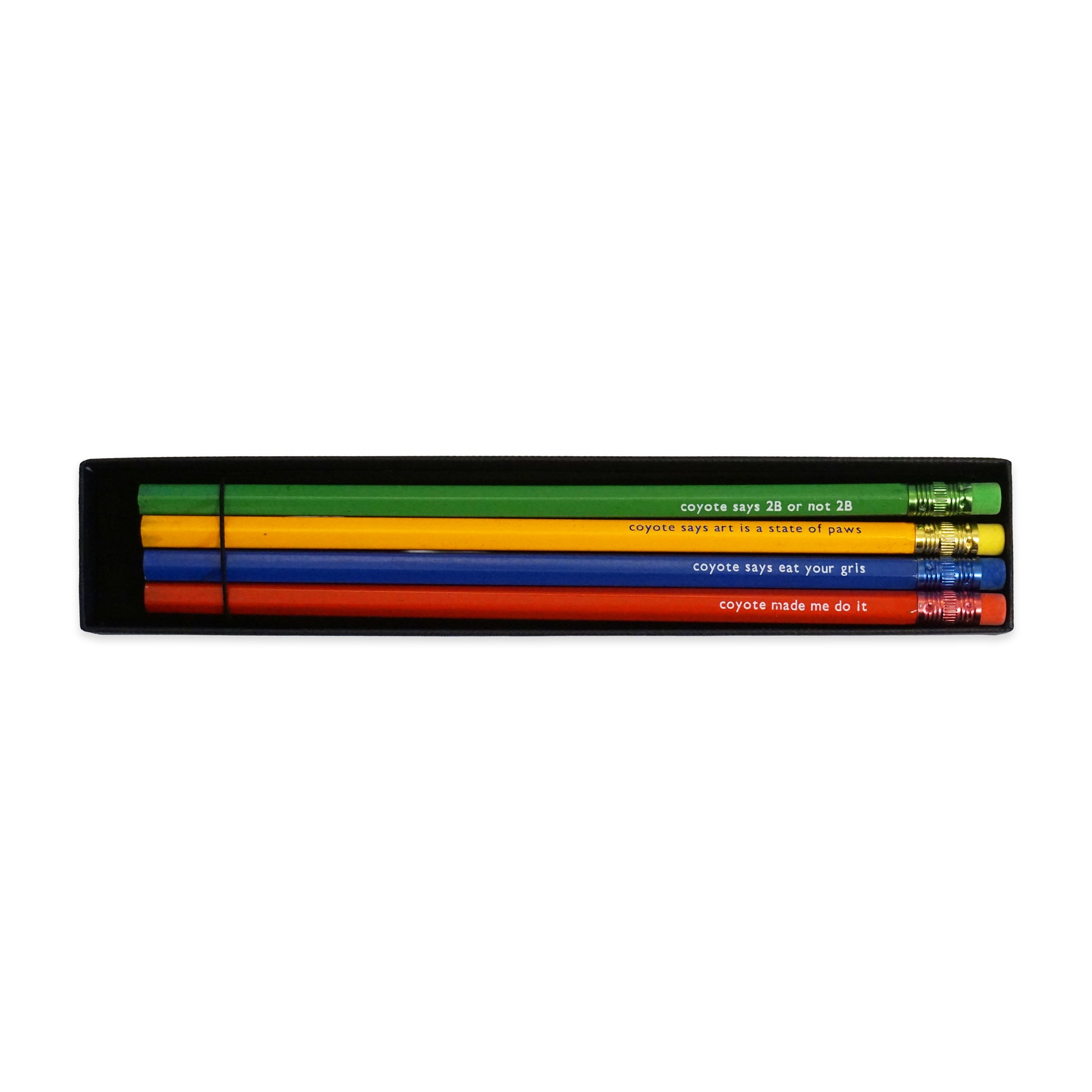 A set of four pencils in a black box, each a different colour: yellow, green, red, and blue. Each pencil has a humorous phrase printed in white, such as "coyote says 2B or not 2B" and "coyote made me do it".