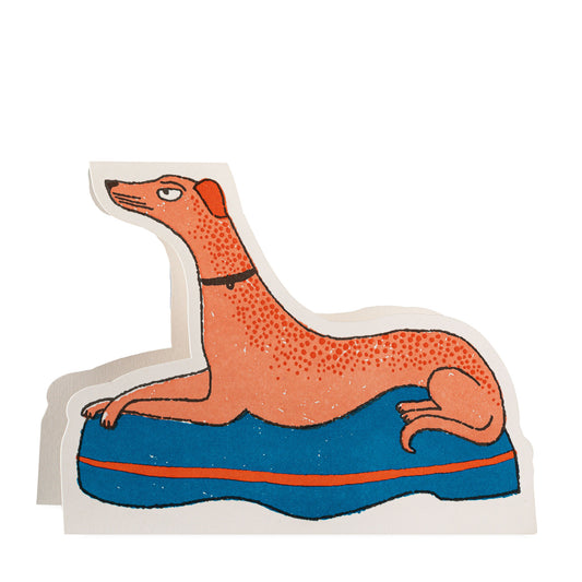 Illustration of a dog lying on a blue cushion with red trim on a white background
