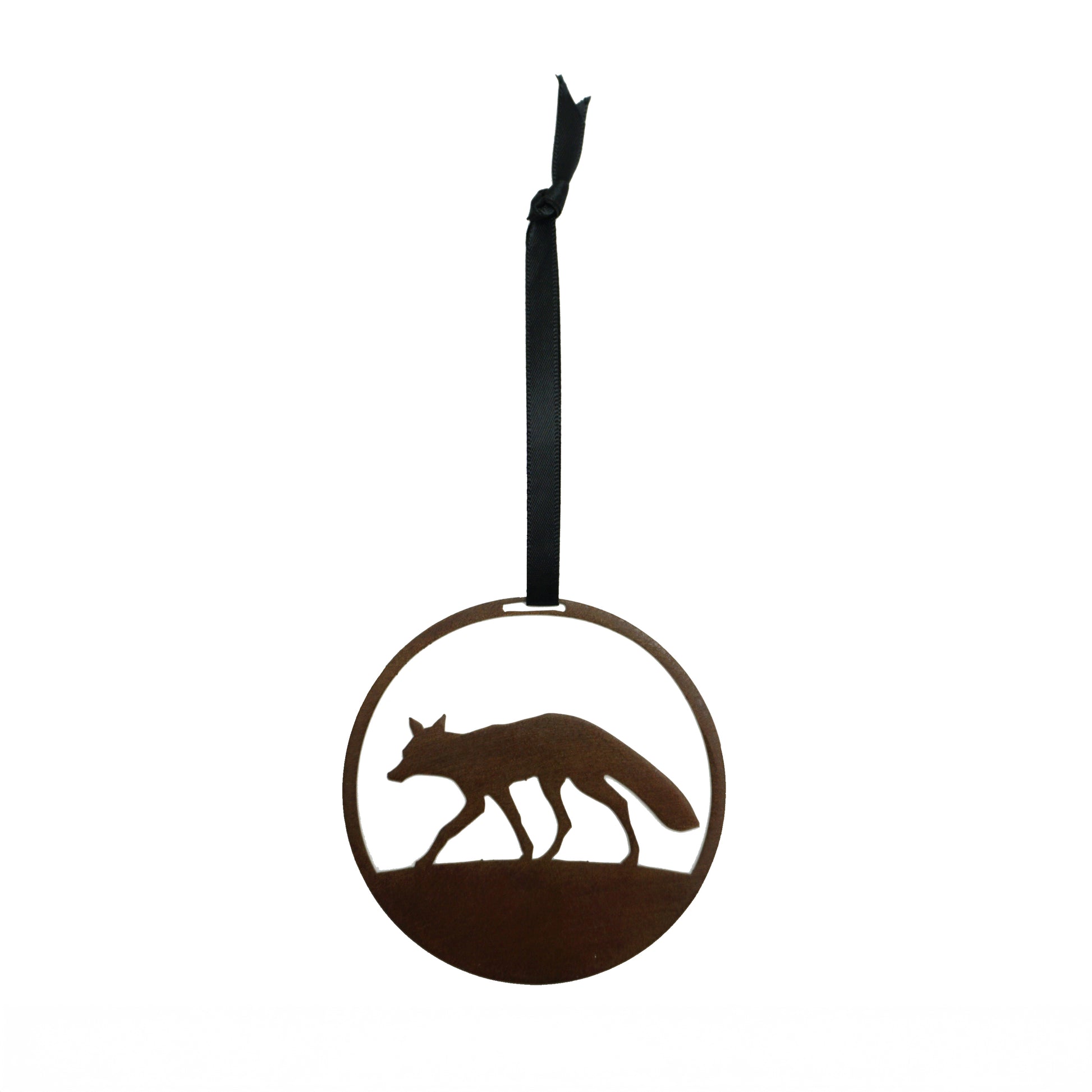 Decorative laser cut round metal ornament with fox silhouette on a plain white background, hanging from a black ribbon.