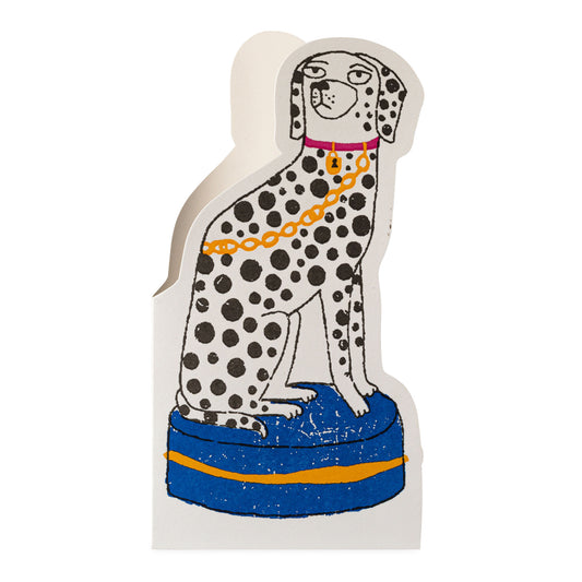 cut-out greetings card of a dalmatian dog with a blue base and gold chain on a white background
