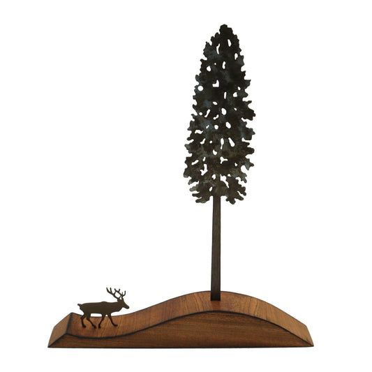 Decorative metal sculpture of a tree and stag on a wooden base against a white background