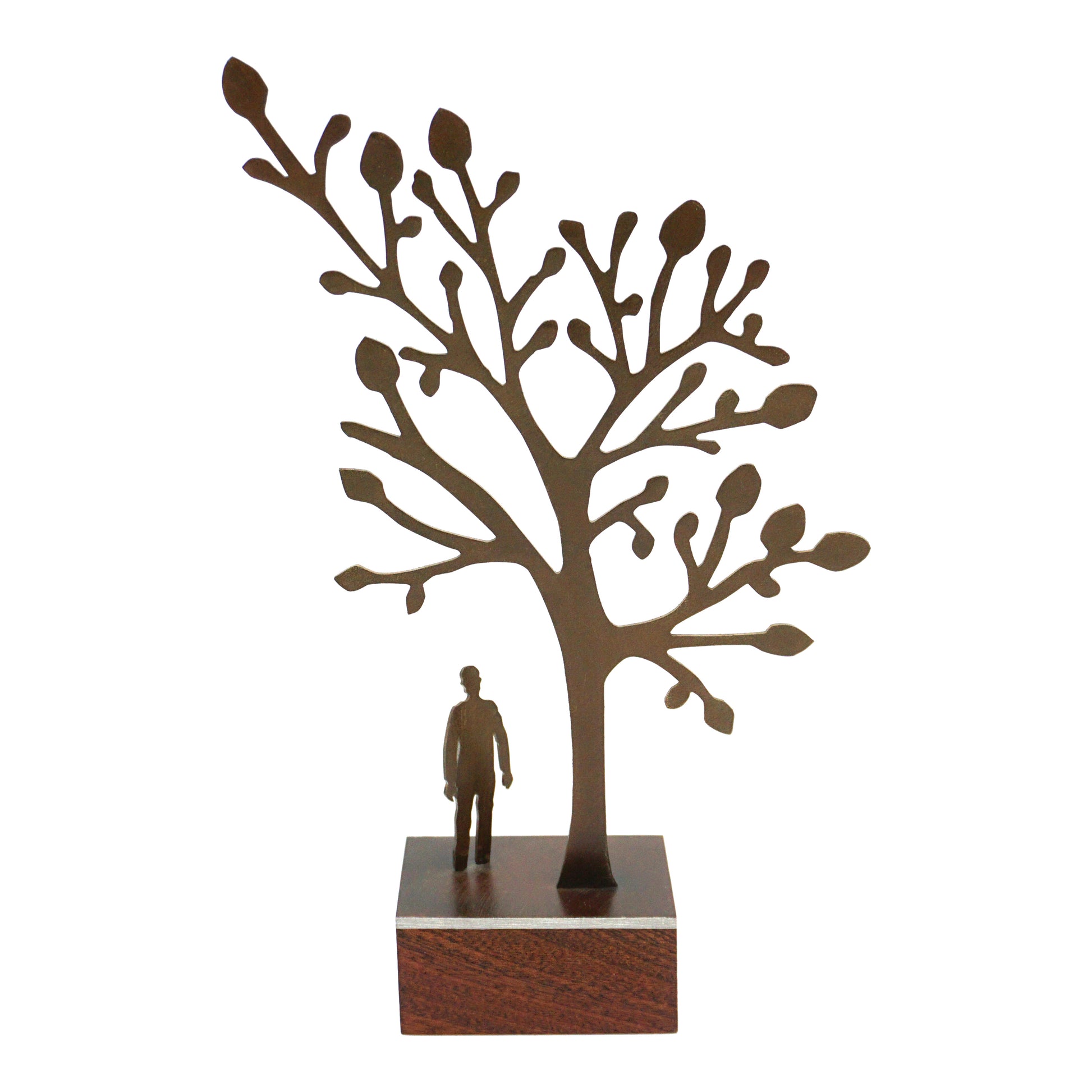 Decorative sculpture of a tree with a person underneath looking up on a plain white background.