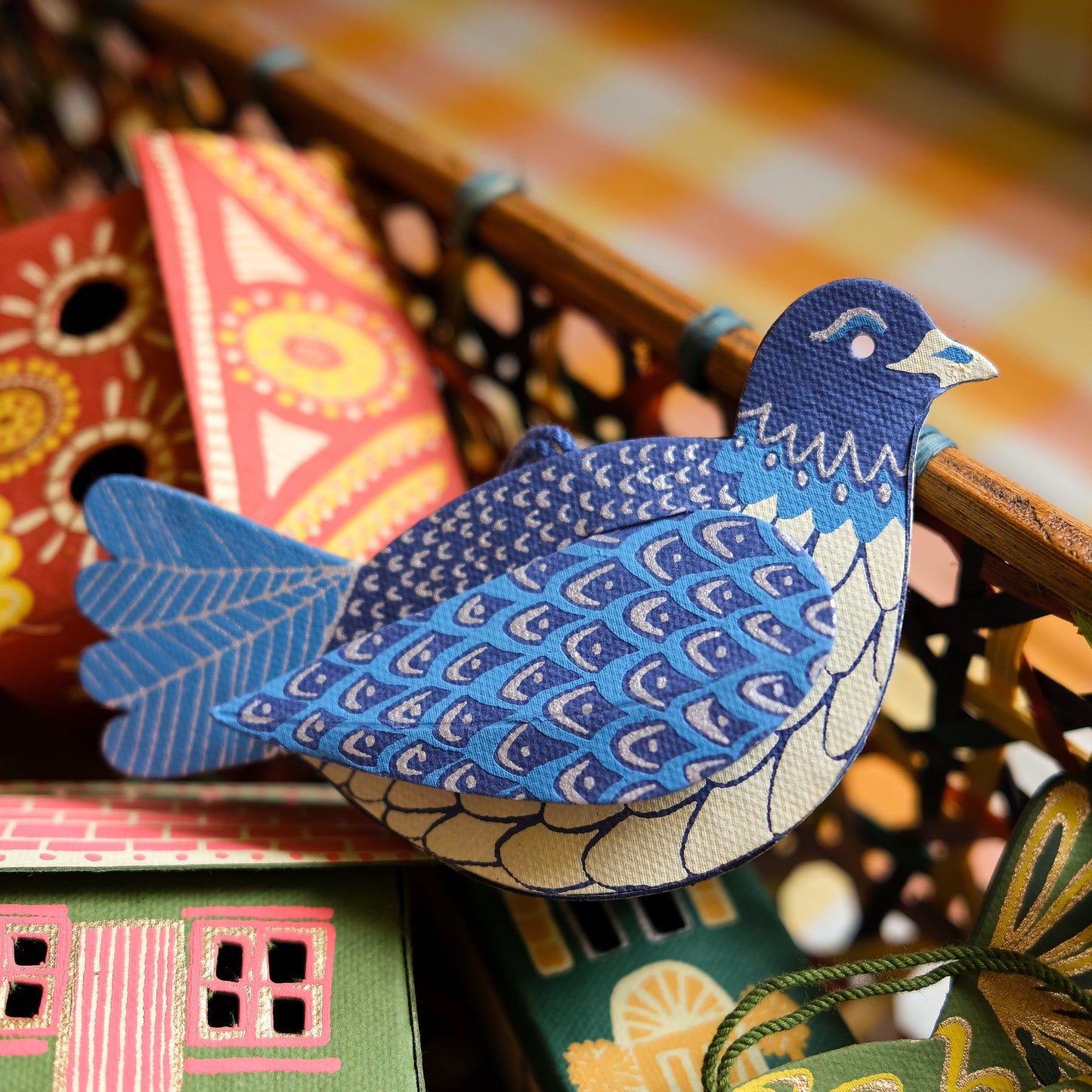 Colourful paper dove decorations on a textured surface