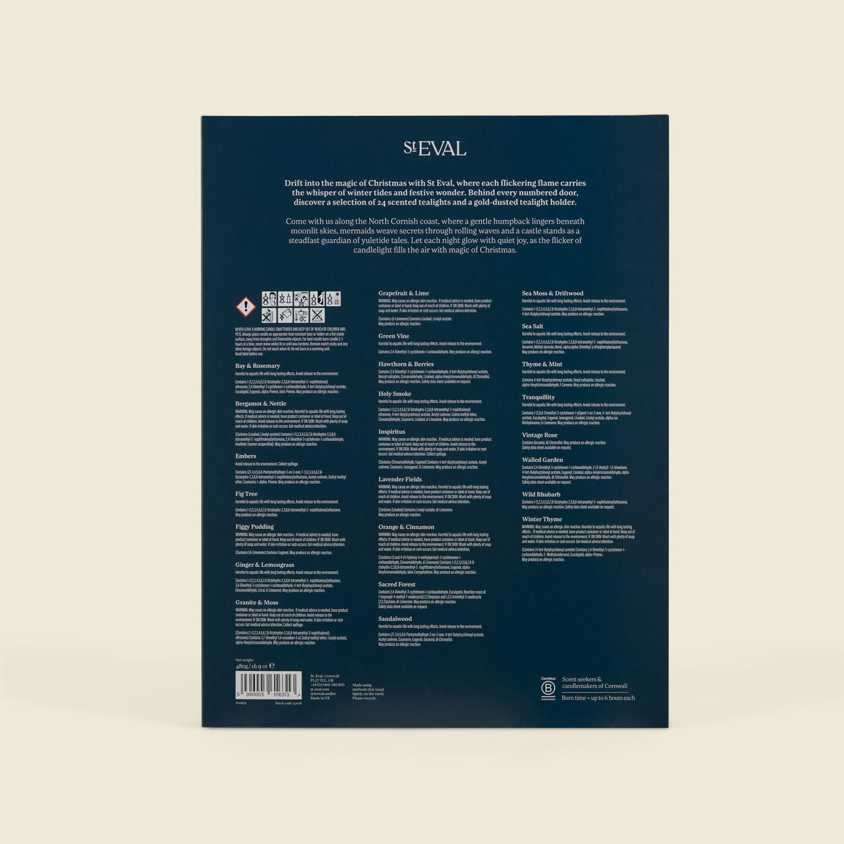 The back cover of a dark navy blue advent calendar  featuring multiple columns of white text, a barcode, and small logos at the bottom, photographed against a light beige background.