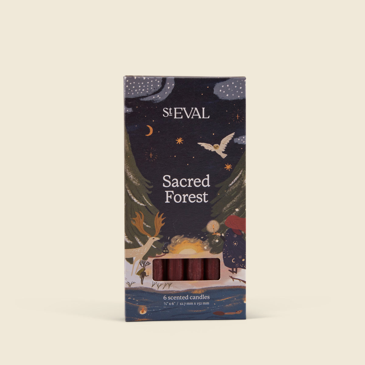 A boxed candle product labelled 'Sacred Forest' with illustrated forest and night-sky artwork, shown upright on a plain warm off-white background. A small window near the bottom reveals reddish-brown wax candles inside.