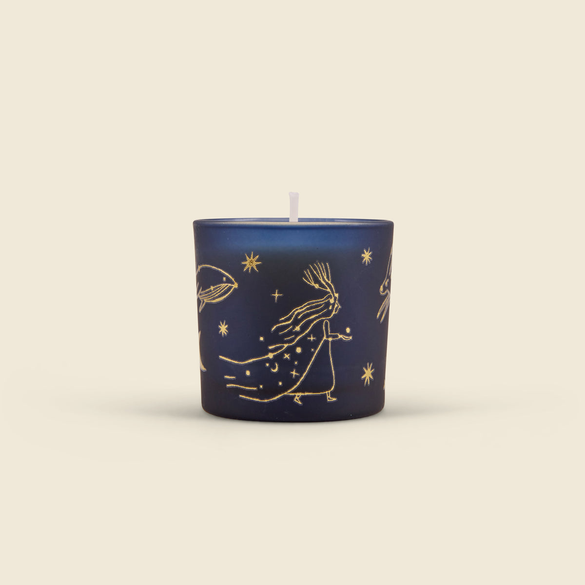 A navy blue glass candle jar with gold celestial line art illustrations, including a rabbit, stars, and a crescent moon, shown on a solid light beige background.