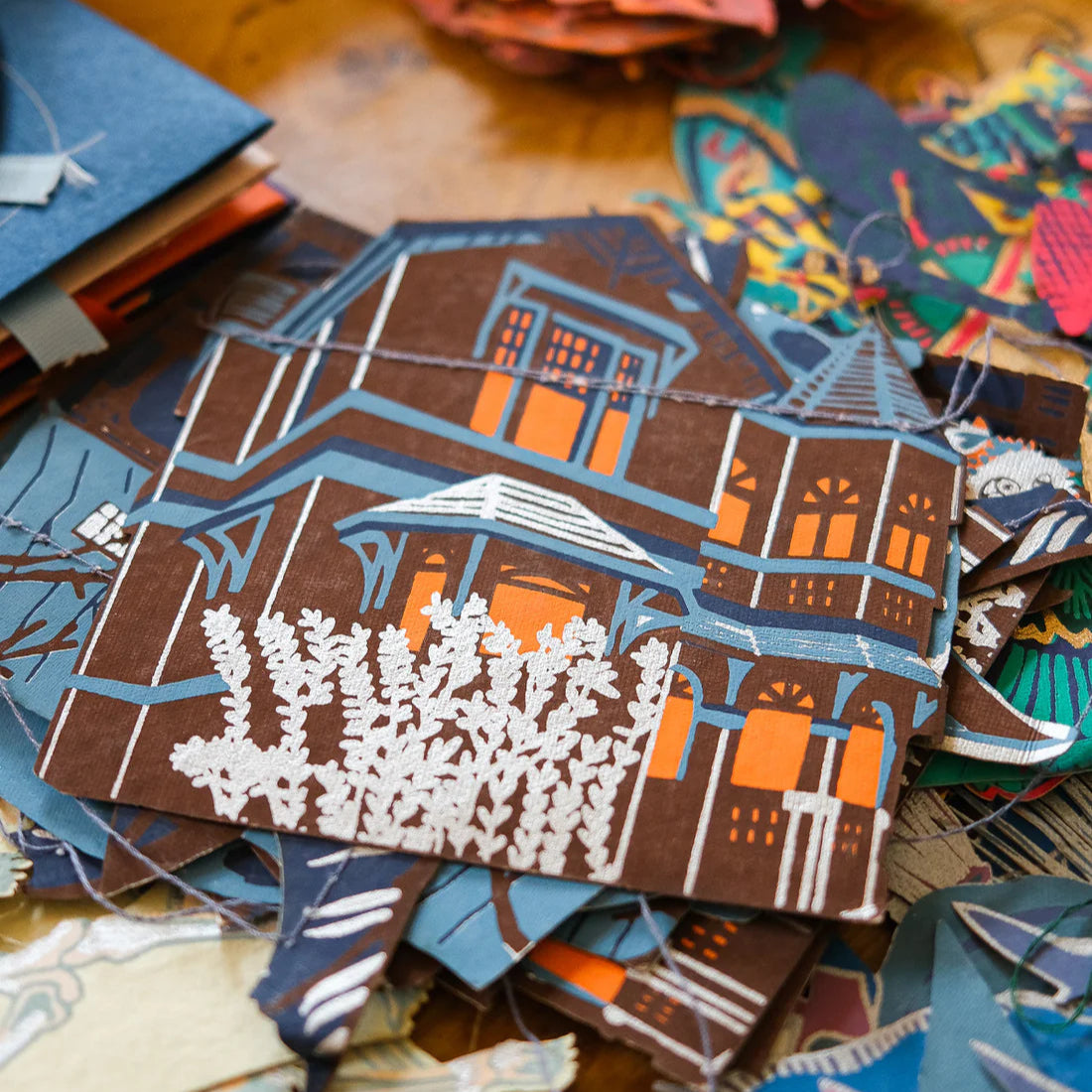 A close up shot of a blue, brown and orange cut out haunted house. 