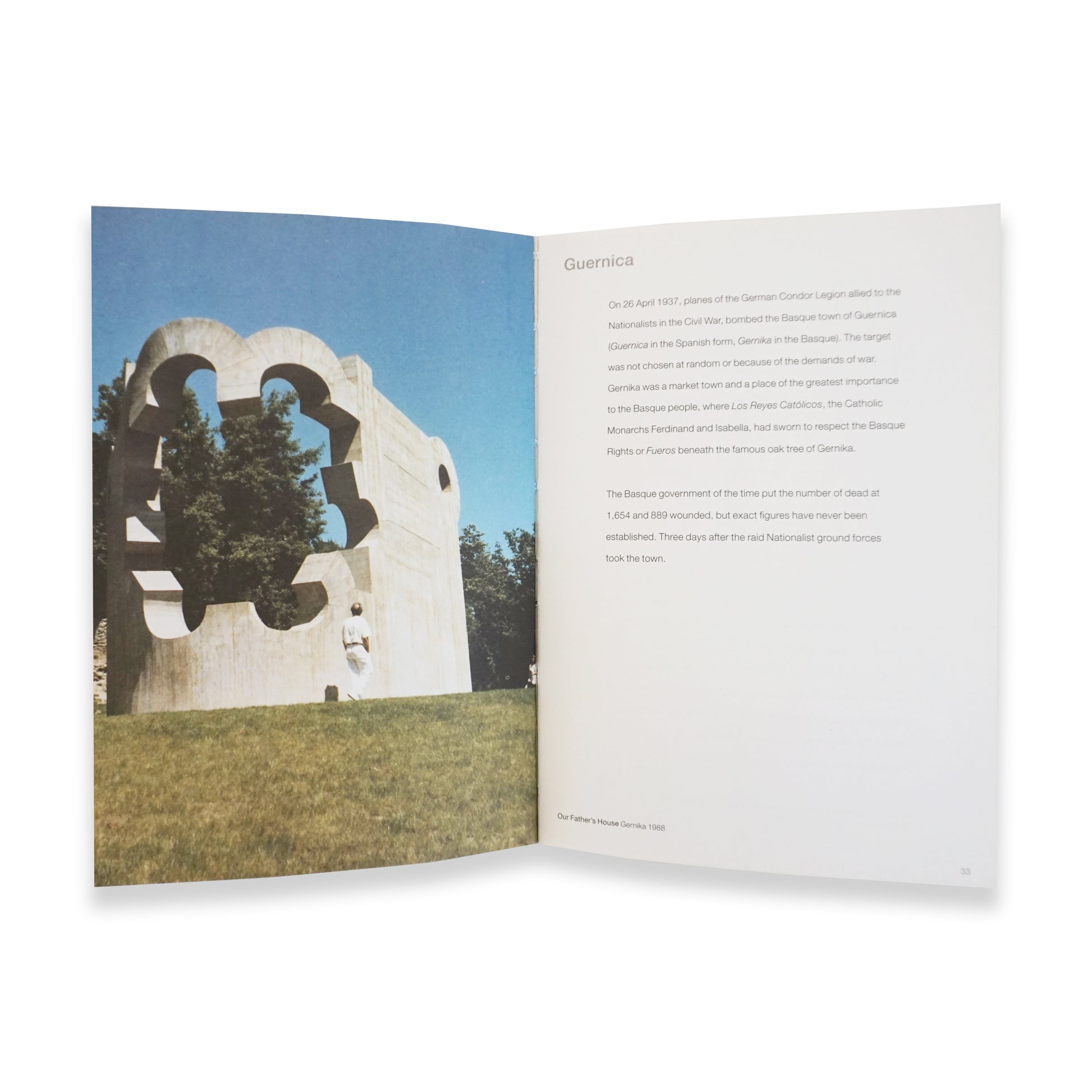 Open book with a photograph of a sculpture and text on a white background
