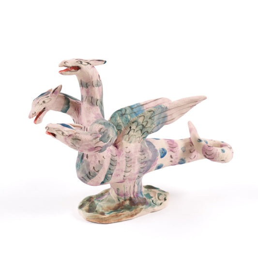 Colourful dragon-like ceramic whistle on a white background. The hydra has three heads, wings and a tail.