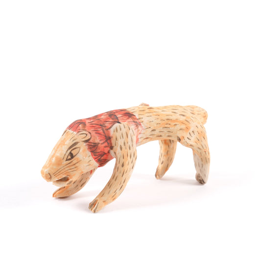 A painted ceramic lion whistle in shades of orange and red on a plain white background.