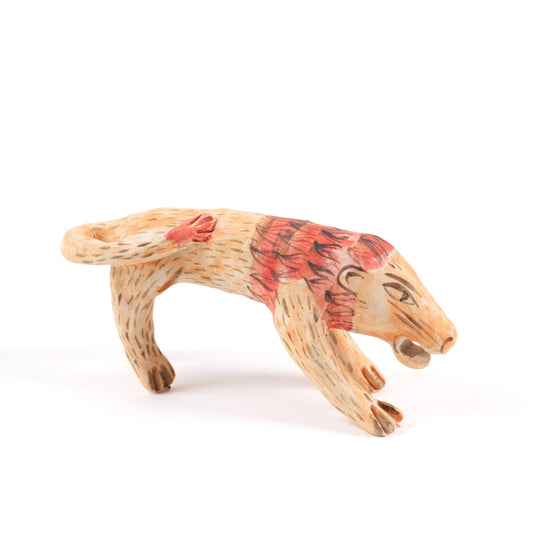 A painted ceramic lion whistle in shades of orange and red on a plain white background.
