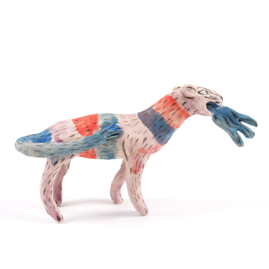 A painted ceramic panther whistle in shades of blue, pink and orange. The panther appears to be breathing blue fire. One a plain white background.
