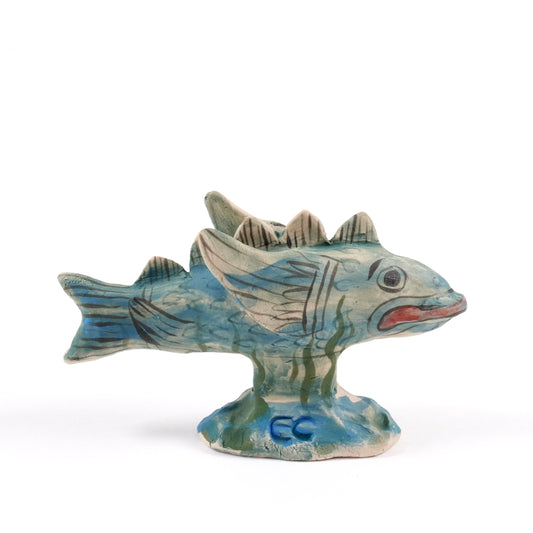 Painted ceramic fish whistle with blue and green patterns on a white background