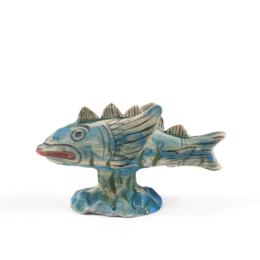 Painted ceramic fish whistle with blue and green patterns on a white background