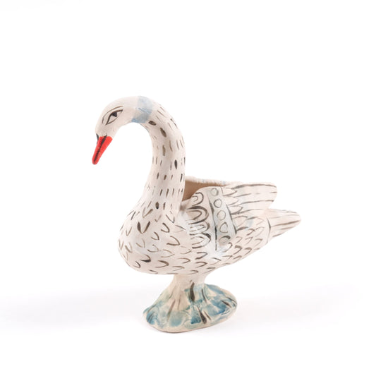 Painted ceramic swan whistle with an orange beak on a plain white background.
