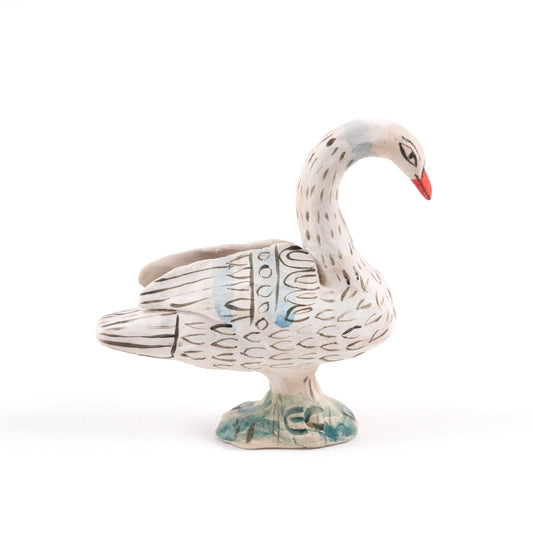 Painted ceramic swan whistle with an orange beak on a plain white background.