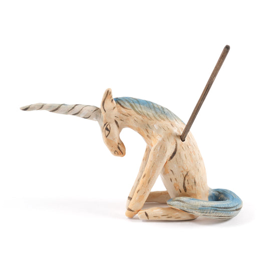 A painted ceramic unicorn whistle in shades of beige with a blue mane and tail on a plain white background.