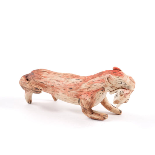 A painted ceramic weasel whistle in shades of brown and red on a plain white background.